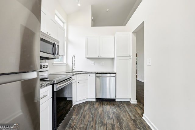 kitchen featuring white cabinetry, appliances with stainless steel finishes, dark wood-type flooring, and sink