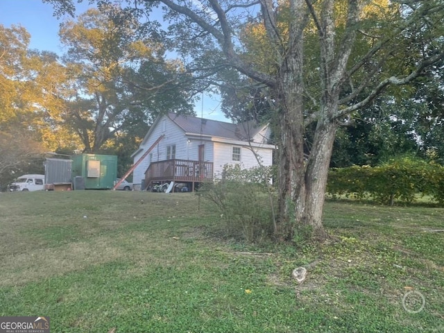 view of yard with a deck and a shed