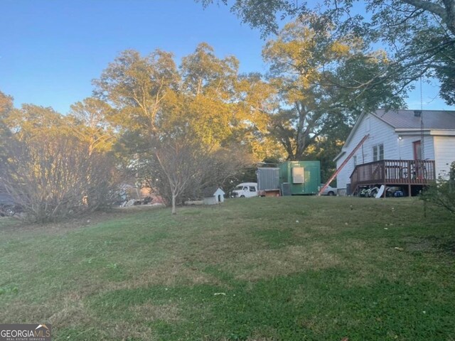 view of yard with a storage shed and a deck