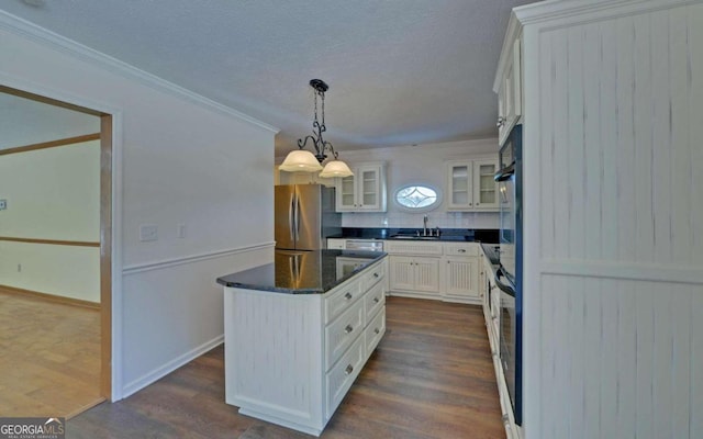 kitchen with sink, decorative light fixtures, white cabinetry, stainless steel refrigerator, and dark hardwood / wood-style floors