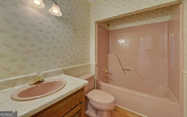 full bathroom featuring shower / bathtub combination, hardwood / wood-style flooring, vanity, and toilet