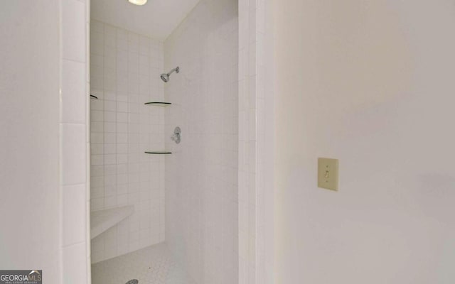 bathroom with a tile shower