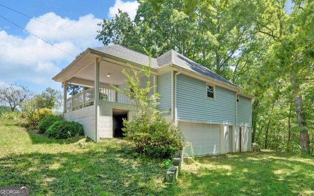 view of property exterior with a yard and a garage