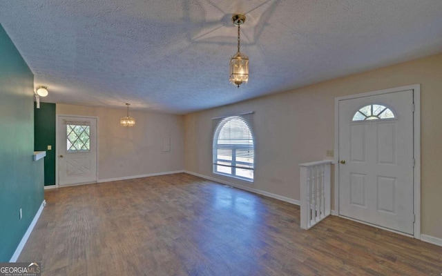 entrance foyer with a textured ceiling and hardwood / wood-style floors