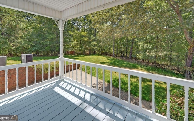 deck with a lawn and central AC