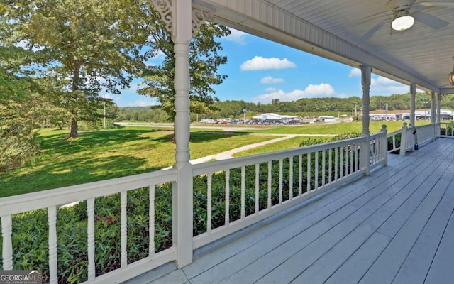 deck featuring a lawn and ceiling fan