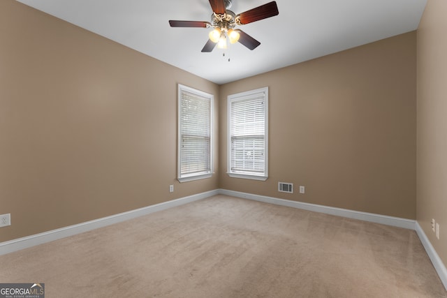 carpeted empty room featuring ceiling fan