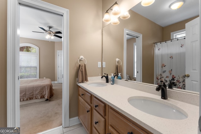 bathroom with tile patterned flooring, vanity, and ceiling fan