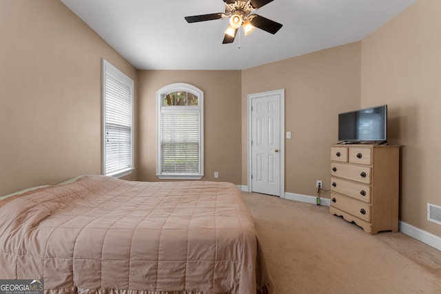 bedroom with light carpet and ceiling fan