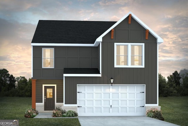 view of front of house featuring a garage and a lawn