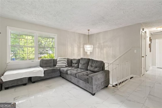 living room featuring a textured ceiling and an inviting chandelier