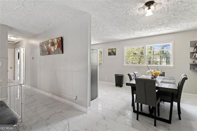 dining space featuring a textured ceiling