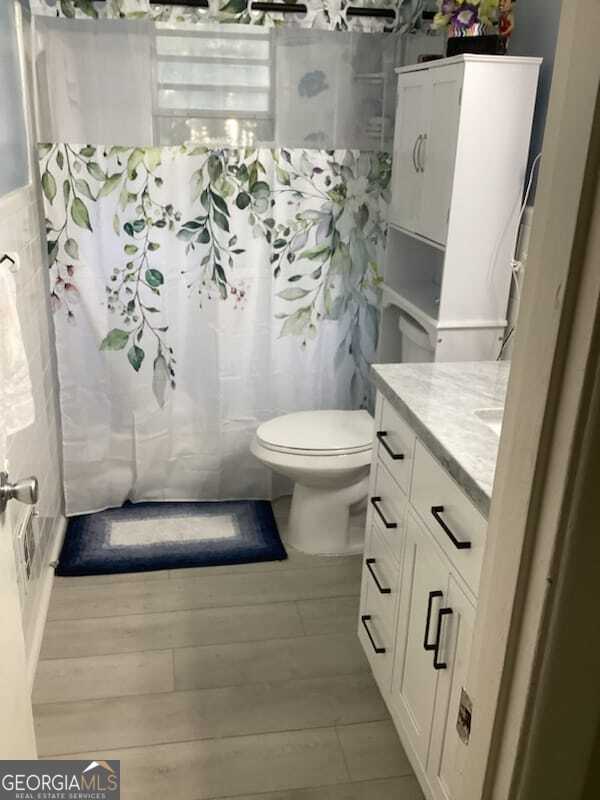 bathroom featuring vanity, toilet, and tile patterned floors