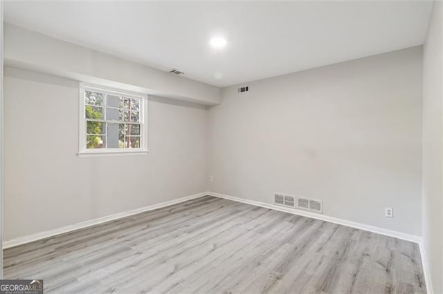 spare room featuring light hardwood / wood-style flooring