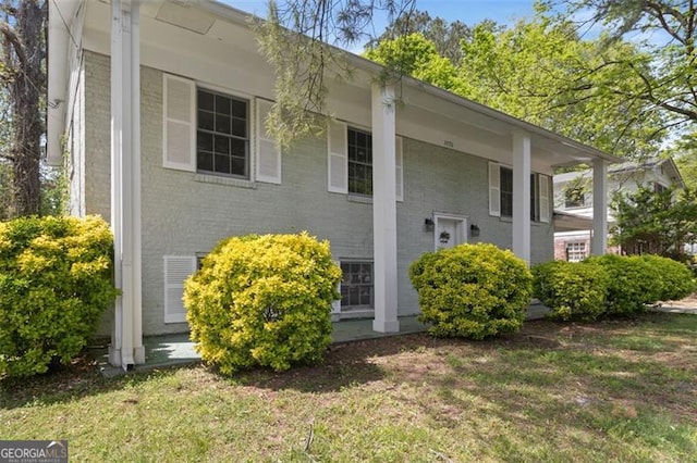 view of side of property with a yard