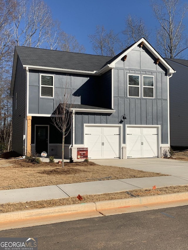 view of front of house featuring an attached garage, driveway, and board and batten siding