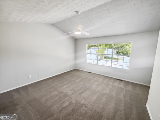 carpeted spare room with a ceiling fan, baseboards, a textured ceiling, and vaulted ceiling