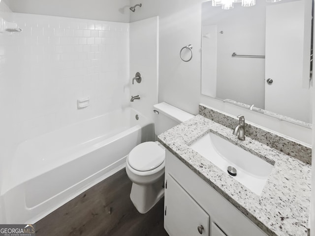 bathroom featuring bathing tub / shower combination, toilet, wood finished floors, and vanity
