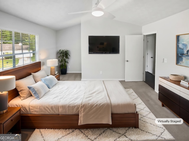 bedroom with vaulted ceiling, carpet flooring, baseboards, and ceiling fan