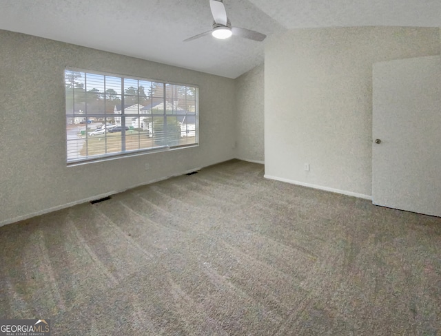 carpeted spare room with lofted ceiling, ceiling fan, and a textured ceiling