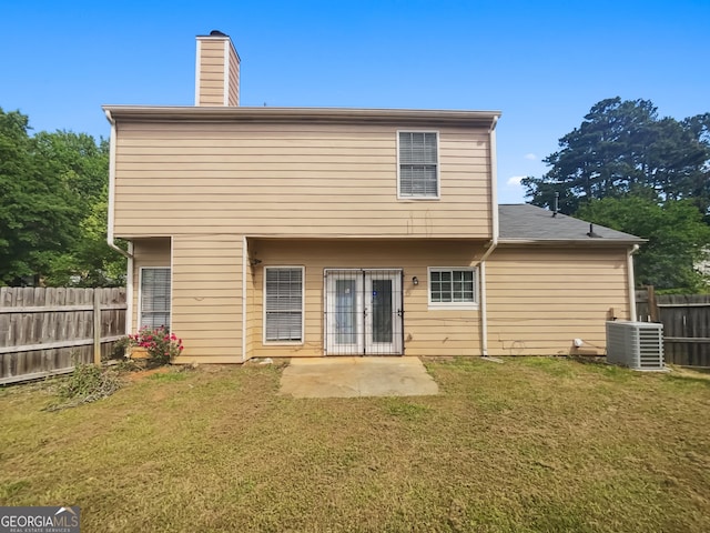 rear view of property featuring central AC, a chimney, and a patio