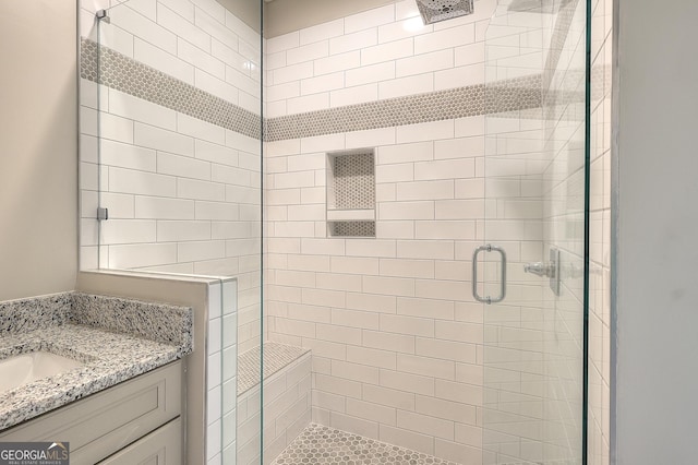 bathroom featuring vanity and a shower with shower door