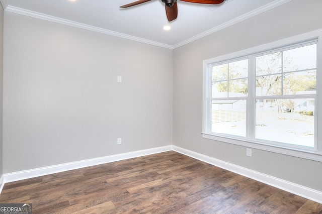 spare room featuring ceiling fan, dark wood-type flooring, and ornamental molding