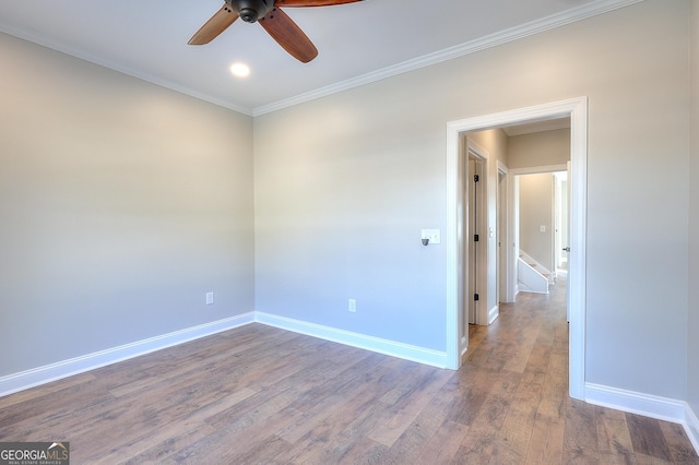 empty room featuring ceiling fan, wood-type flooring, and crown molding