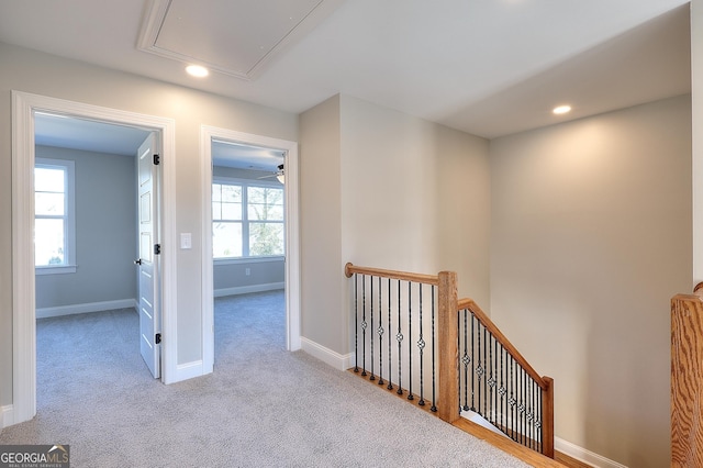 hallway with light colored carpet