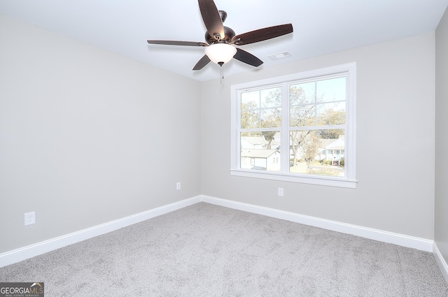 carpeted spare room with ceiling fan