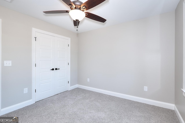 unfurnished bedroom featuring carpet, a closet, and ceiling fan