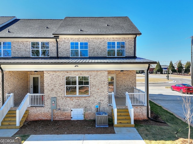 view of front facade featuring covered porch and central AC