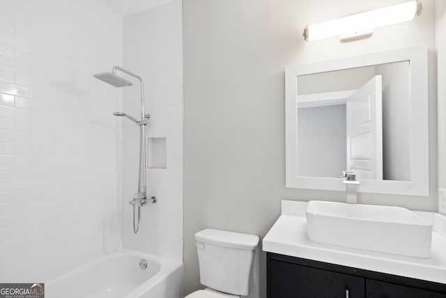 full bathroom featuring tiled shower / bath combo, vanity, and toilet