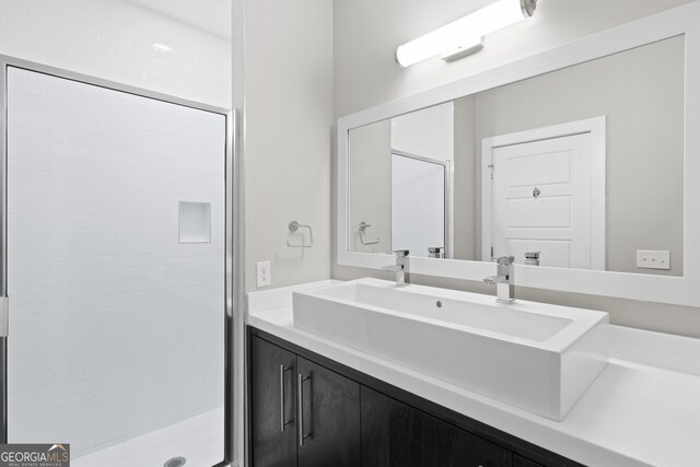 bathroom with vanity and tiled shower