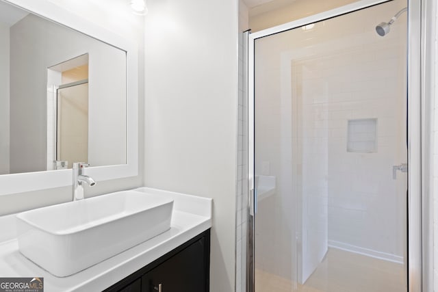 bathroom featuring an enclosed shower and vanity