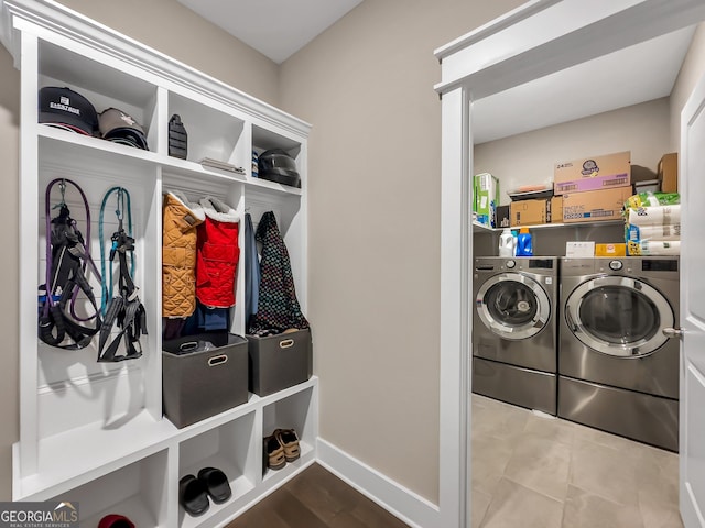 clothes washing area featuring tile patterned flooring and separate washer and dryer