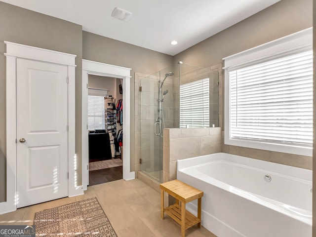 bathroom featuring plus walk in shower and tile patterned floors