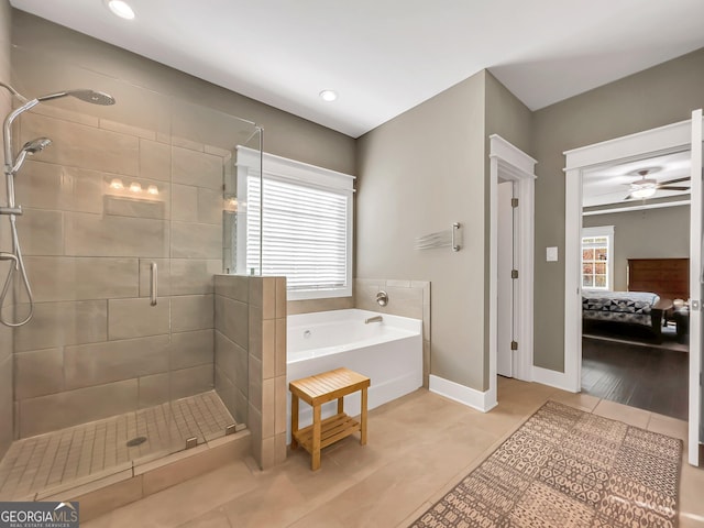 bathroom featuring ceiling fan, plus walk in shower, a healthy amount of sunlight, and wood-type flooring