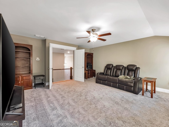 carpeted living room with ceiling fan and lofted ceiling