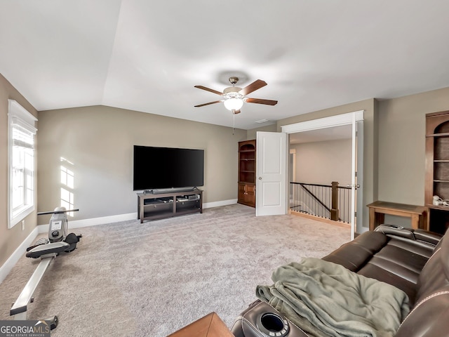 carpeted living room with vaulted ceiling and ceiling fan