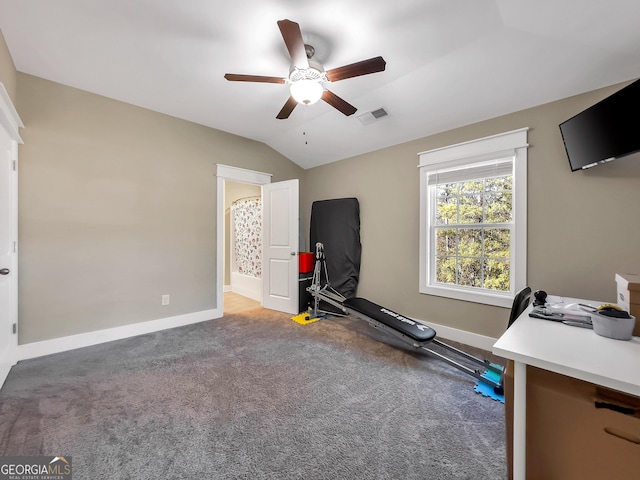 exercise area featuring carpet flooring, ceiling fan, and vaulted ceiling