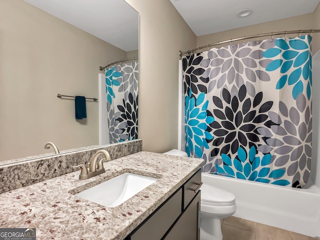 full bathroom featuring tile patterned flooring, shower / bath combo, toilet, and vanity