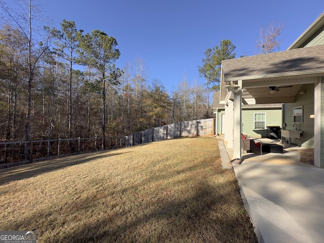 view of yard featuring a patio area, ceiling fan, outdoor lounge area, and sink