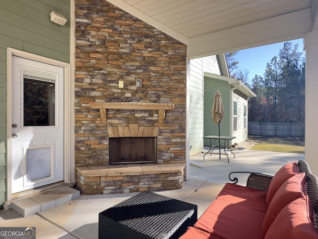 view of patio with an outdoor living space with a fireplace