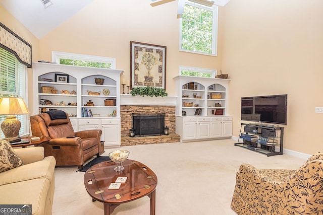 carpeted living room featuring a healthy amount of sunlight, high vaulted ceiling, and a fireplace