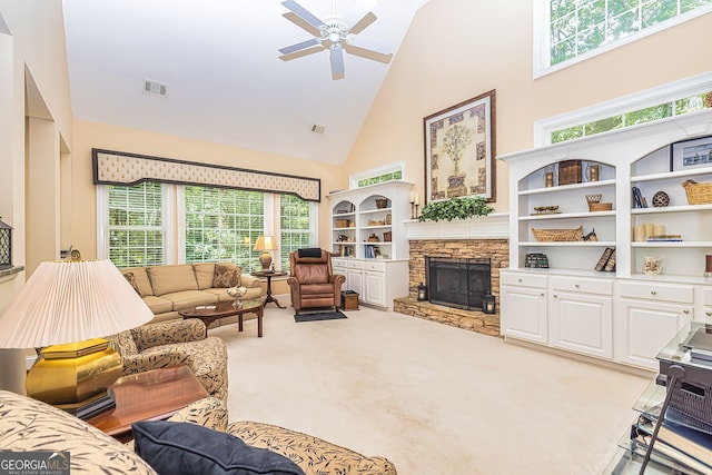 living room featuring high vaulted ceiling, light carpet, ceiling fan, and a fireplace