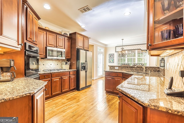 kitchen with light stone counters, light hardwood / wood-style floors, sink, stainless steel appliances, and crown molding