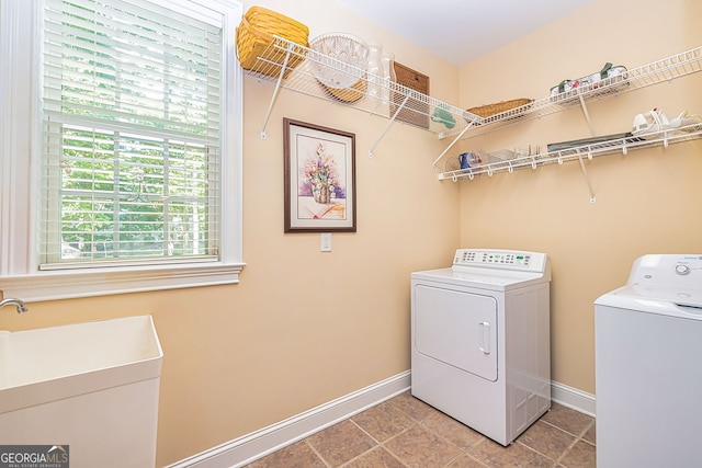 washroom featuring sink, tile patterned floors, and washing machine and dryer