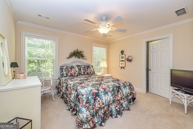 carpeted bedroom with ornamental molding and ceiling fan