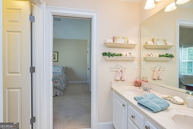 bathroom featuring ornamental molding and vanity